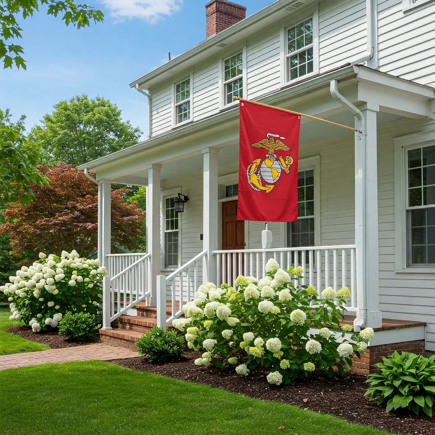 Marine Corps flag flying on residential flagpole in front of colonial-style house