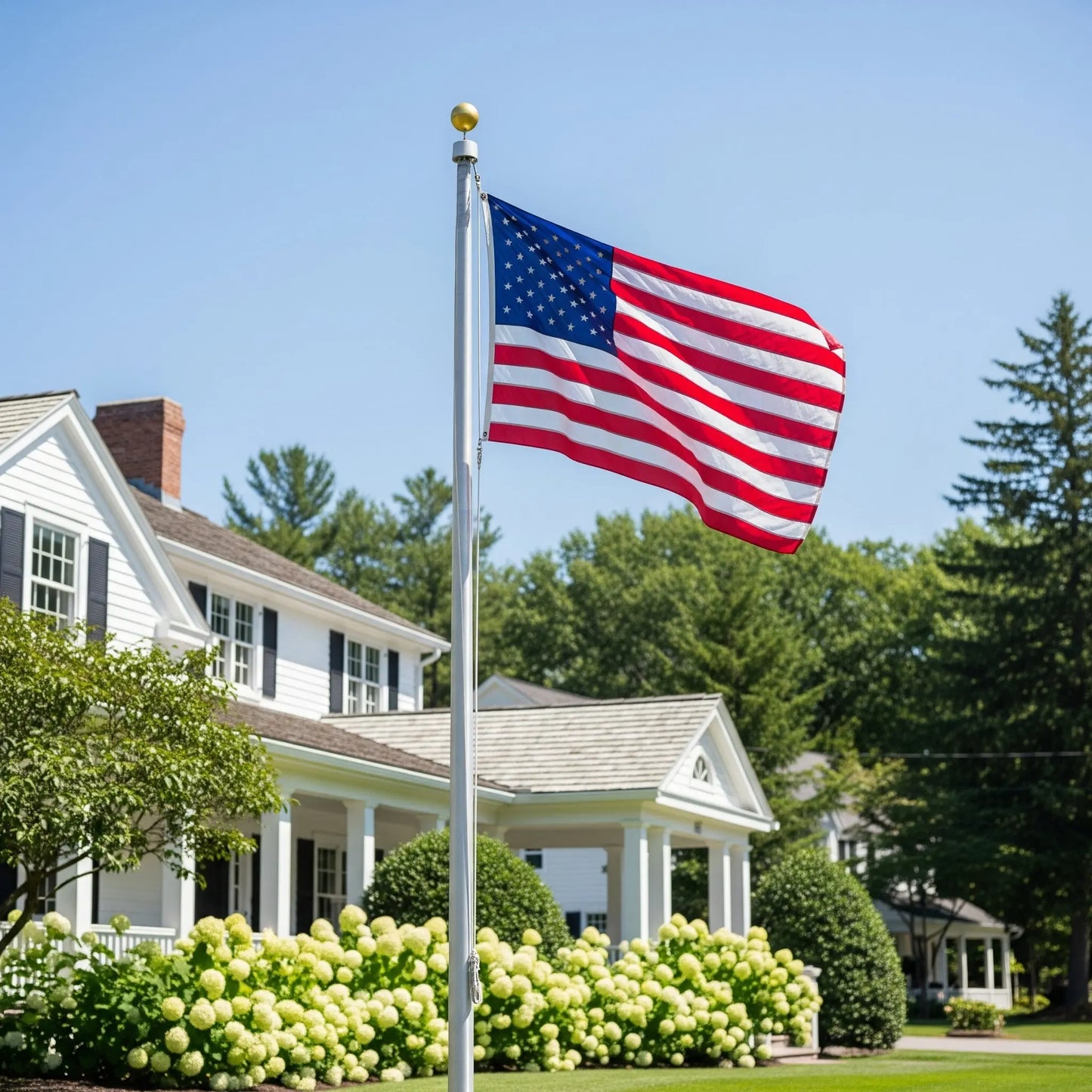 Heavy-Duty Home Flagpole with an American flag in the front yard of a white two story house