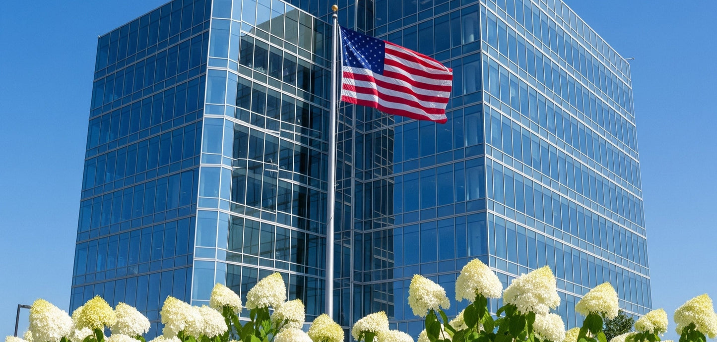 American flag waving in front of business headquarters on sunny day